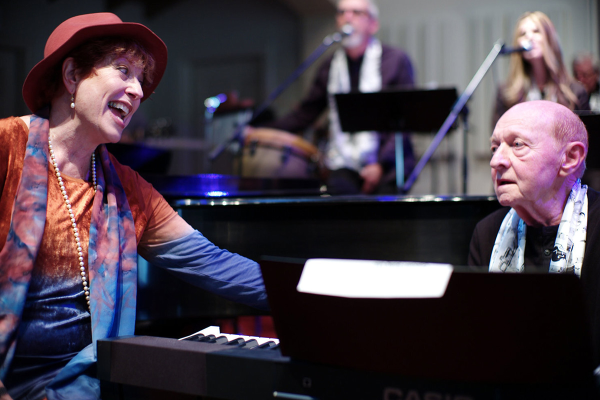 A singer and pianist sharing a moment during a music performance