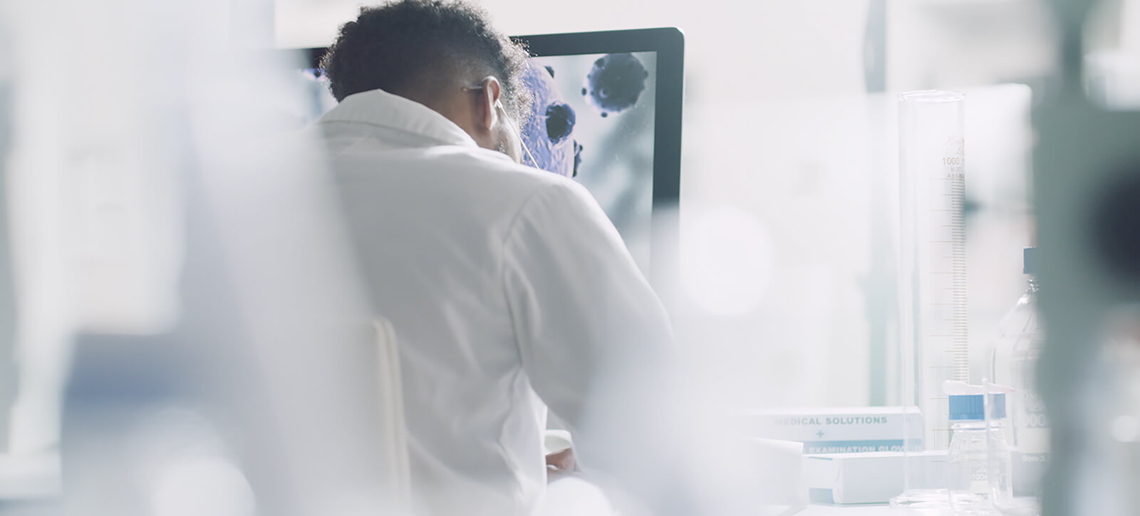 A researcher examining a magnified image on a laboratory monitor